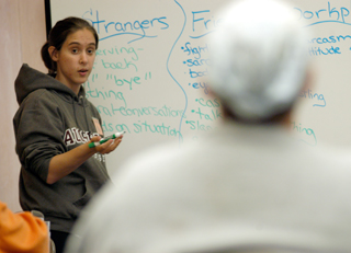 Jeanette Clark teaching in front of whiteboard.